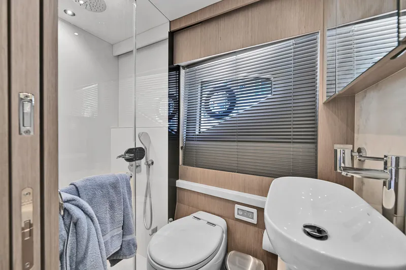  Yacht Photos Pics Luxurious bathroom in 2020 Sunseeker Manhattan 52 yacht, featuring modern fixtures and elegant design.