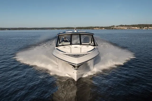  Yacht Photos Pics 2026 Fountain 39 DX boat cruising on a calm lake under clear skies.