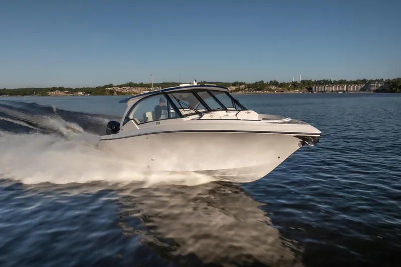  Yacht Photos Pics 2026 Fountain 39 DX boat cruising on a calm lake under clear blue skies.