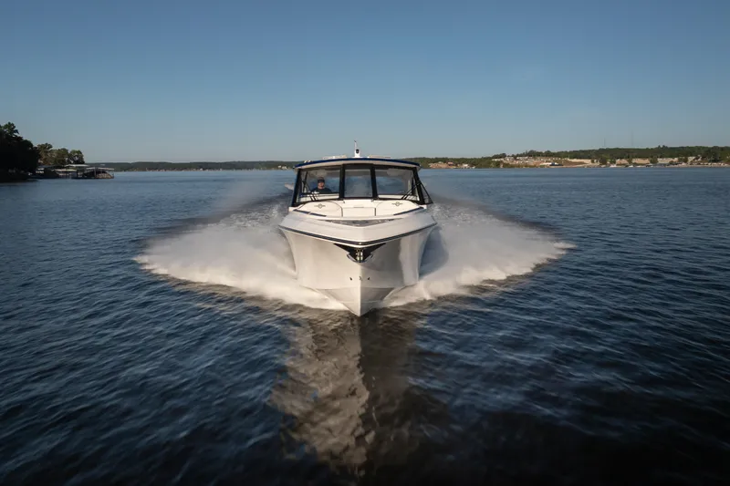  Yacht Photos Pics 2026 Fountain 39 DX boat cruising on a serene lake under a clear blue sky.