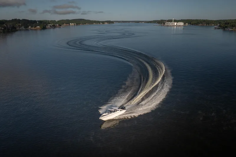  Yacht Photos Pics Fountain 39 DX boat making a sharp turn on a calm lake, 2026 model.