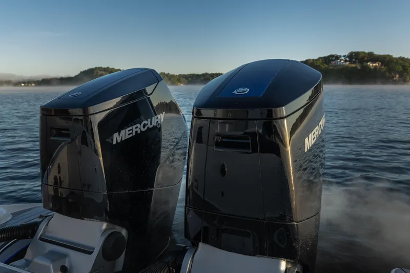  Yacht Photos Pics Twin Mercury outboard engines on a 2026 Fountain 39 DX boat, cruising on a serene lake.