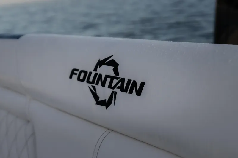  Yacht Photos Pics 2026 Fountain 39 DX boat logo on white upholstery with ocean background.