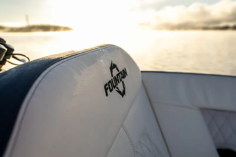  Yacht Photos Pics Fountain 39 DX boat seat with logo, 2026 model, against a serene water backdrop.