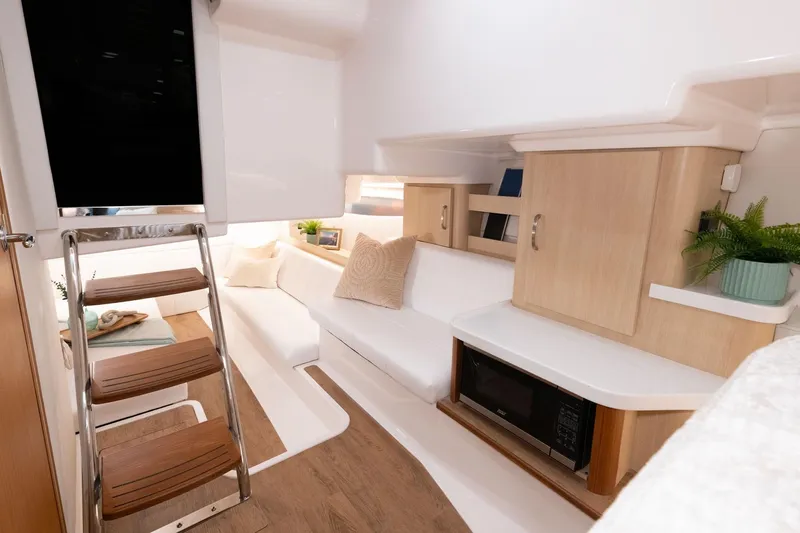  Yacht Photos Pics Manufacturer Provided Image: Interior of 2026 Regal 36 Grande Coupe, featuring modern design with cozy seating and wooden accents.