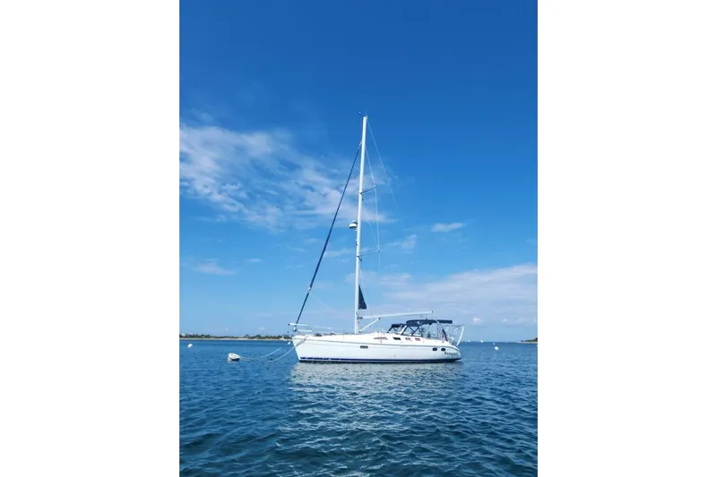 Seaquel Yacht Photos Pics Sailboat Hunter 386, 2003 model, anchored on calm blue waters under clear sky.