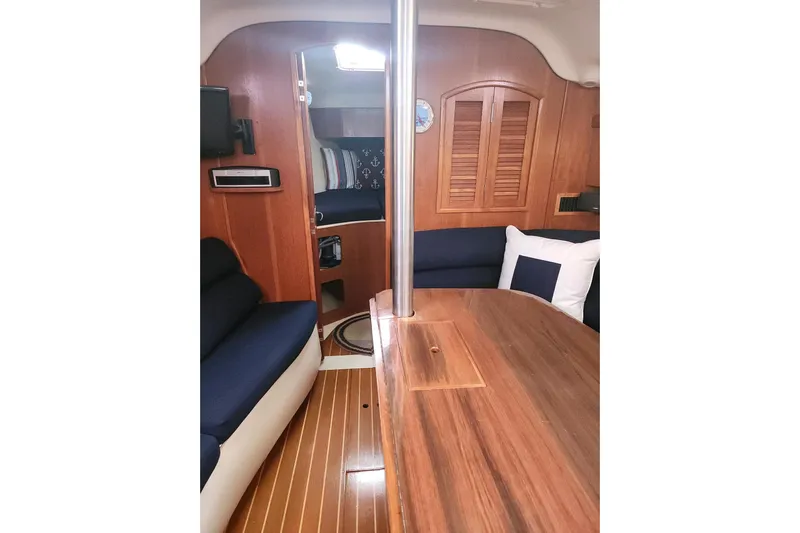 Seaquel Yacht Photos Pics Interior of 2003 Hunter 386 sailboat with wooden finishes and navy seating.
