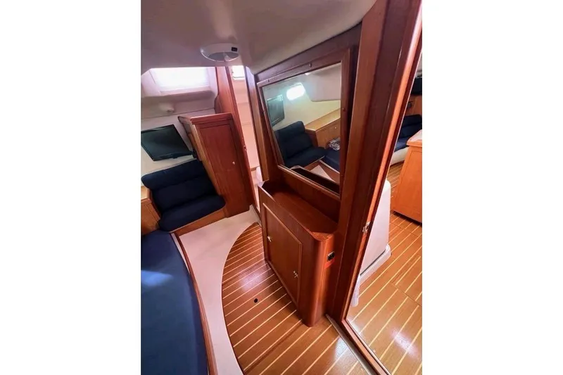 Seaquel Yacht Photos Pics Interior of 2003 Hunter 386 sailboat with wooden finishes and blue seating.