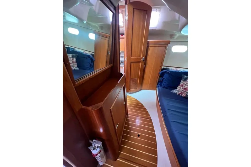 Seaquel Yacht Photos Pics Interior of 2003 Hunter 386 sailboat with wooden cabinetry and blue seating.