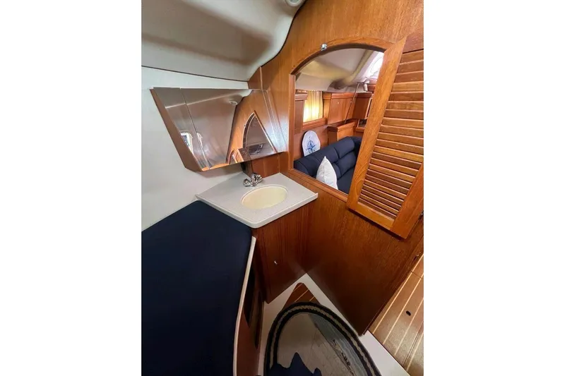 Seaquel Yacht Photos Pics Interior of 2003 Hunter 386 yacht with wooden finish and compact sink area.