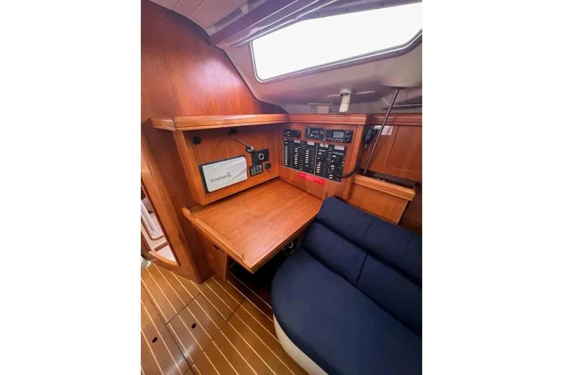 Seaquel Yacht Photos Pics Interior of 2003 Hunter 386 sailboat with navigation equipment and wooden cabinetry.