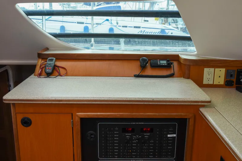 Sangaris Yacht Photos Pics Navigation station inside 2005 Manta 42 MkII catamaran with control panel and communication devices.