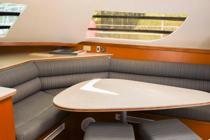 Sangaris Yacht Photos Pics Interior of 2005 Manta 42 MkII yacht with cozy seating and table.