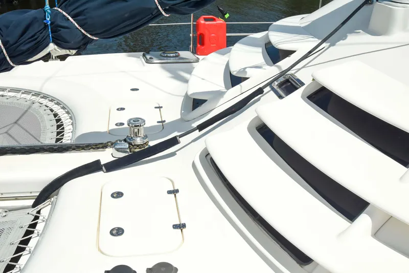 Sangaris Yacht Photos Pics 2005 Manta 42 MkII catamaran deck with winch, steps, and red fuel canister.