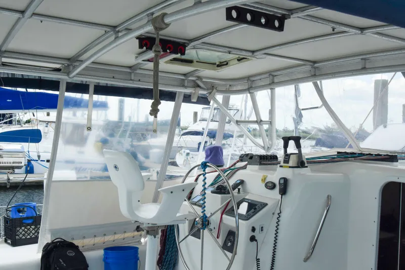 Sangaris Yacht Photos Pics Interior view of a 2005 Manta 42 MkII catamaran cockpit with steering wheel and navigation equipment.