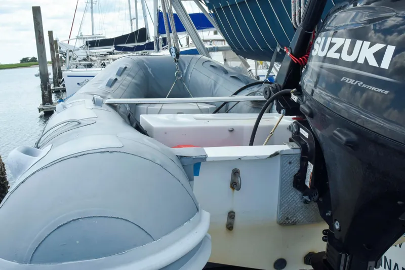 Sangaris Yacht Photos Pics Inflatable boat with Suzuki outboard motor, docked near a 2005 Manta 42 MkII sailboat.