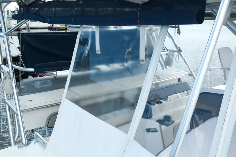 Sangaris Yacht Photos Pics 2005 Manta 42 MkII sailboat with clear cockpit enclosure and marina background.