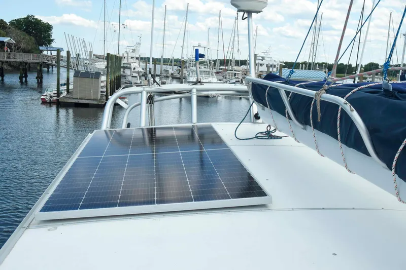 Sangaris Yacht Photos Pics 2005 Manta 42 MkII catamaran with solar panels docked at a marina.