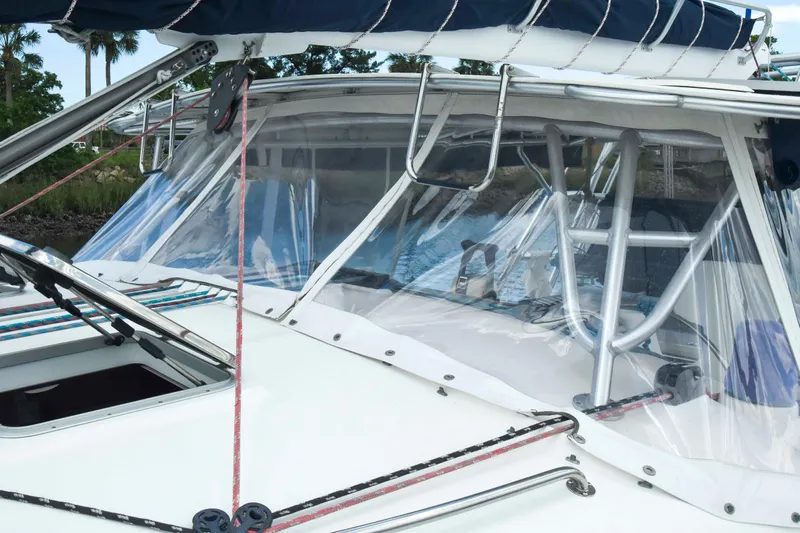 Sangaris Yacht Photos Pics 2005 Manta 42 MkII sailboat with clear cockpit enclosure and blue canvas cover.