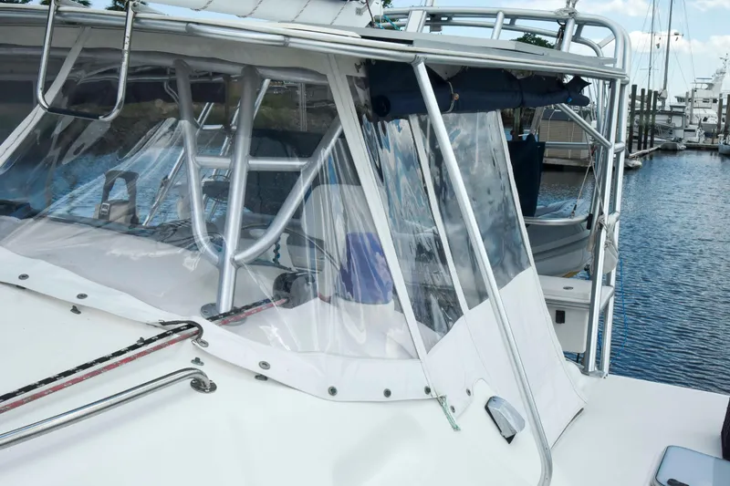 Sangaris Yacht Photos Pics 2005 Manta 42 MkII sailboat with clear cockpit enclosure, docked at marina.