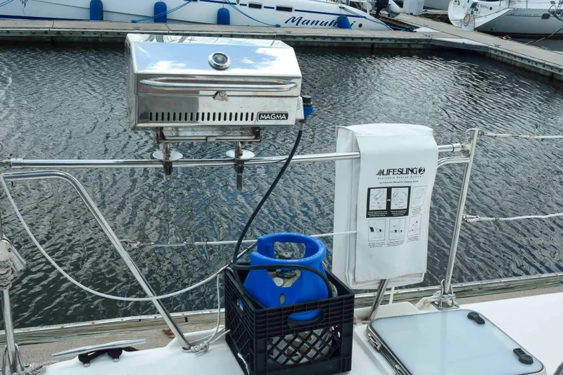 Sangaris Yacht Photos Pics Outdoor grill and propane tank on 2005 Manta 42 MkII yacht deck by marina.