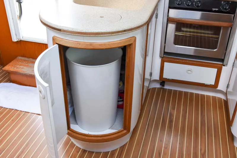 Sangaris Yacht Photos Pics 2005 Manta 42 MkII yacht kitchen with open cabinet and built-in trash bin.