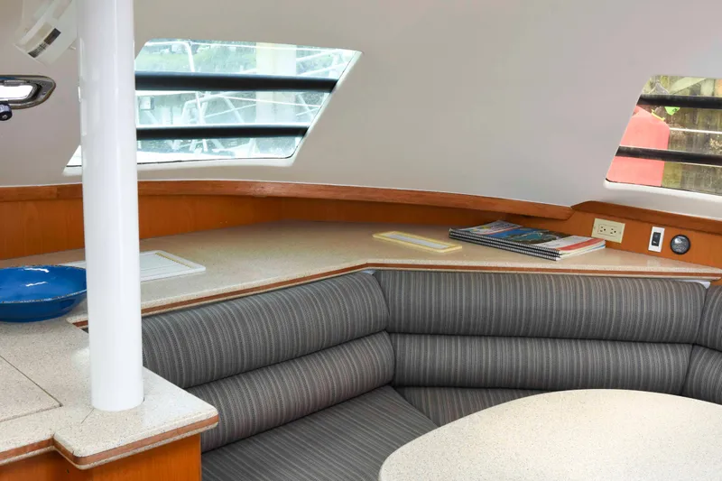 Sangaris Yacht Photos Pics Interior of 2005 Manta 42 MkII yacht with striped seating and wooden accents.