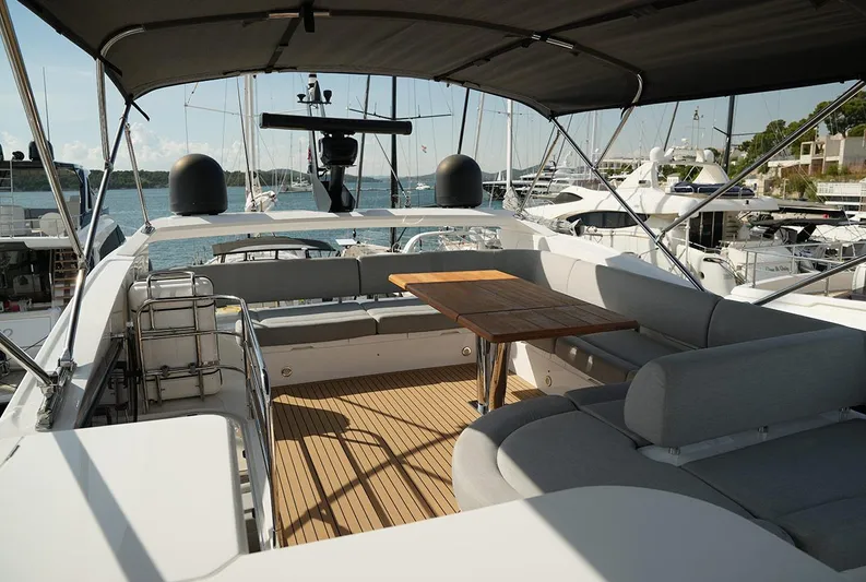  Yacht Photos Pics Luxurious 2017 Sunseeker Manhattan 66 yacht deck with seating and table, docked at marina.