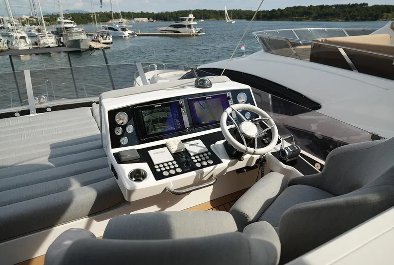  Yacht Photos Pics Luxurious 2017 Sunseeker Manhattan 66 yacht helm with advanced navigation controls, docked in marina.