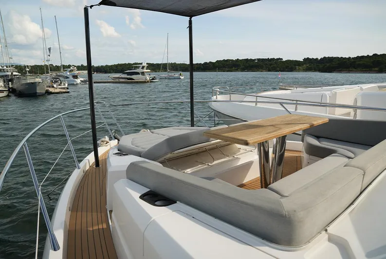  Yacht Photos Pics Sunseeker Manhattan 66 yacht deck with seating and table, docked in a marina, 2017 model.