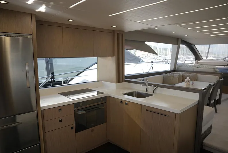  Yacht Photos Pics Luxurious interior of 2017 Sunseeker Manhattan 66 yacht with modern kitchen and seating area.