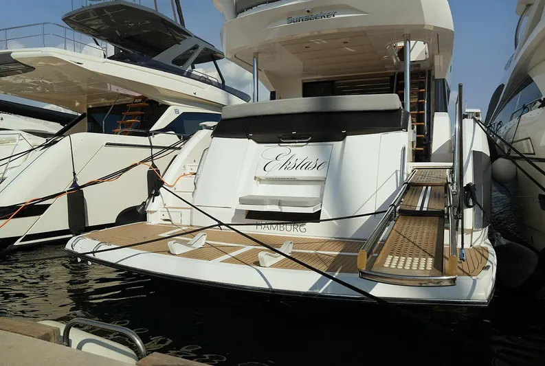  Yacht Photos Pics 2017 Sunseeker Manhattan 66 yacht docked, rear view with boarding platform.