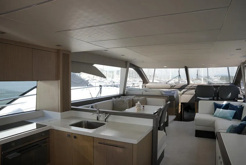  Yacht Photos Pics Luxurious interior of 2017 Sunseeker Manhattan 66 yacht with modern kitchen and seating area.