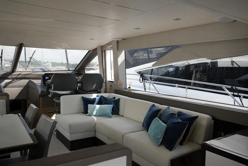  Yacht Photos Pics Luxurious interior of 2017 Sunseeker Manhattan 66 yacht with modern seating and helm station.