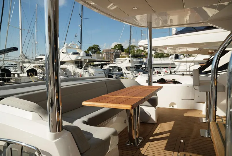  Yacht Photos Pics Luxurious 2017 Sunseeker Manhattan 66 yacht deck with seating and table, docked at marina.