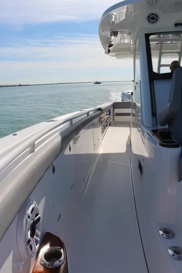  Yacht Photos Pics 2024 Everglades 395 Center Console boat on calm water, showcasing sleek deck design.