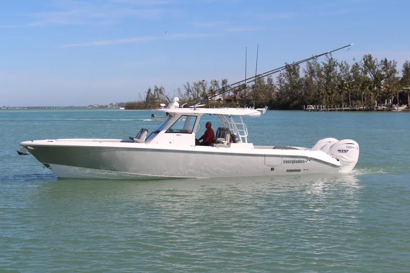  Yacht Photos Pics 2024 Everglades 395 Center Console boat cruising on calm water.