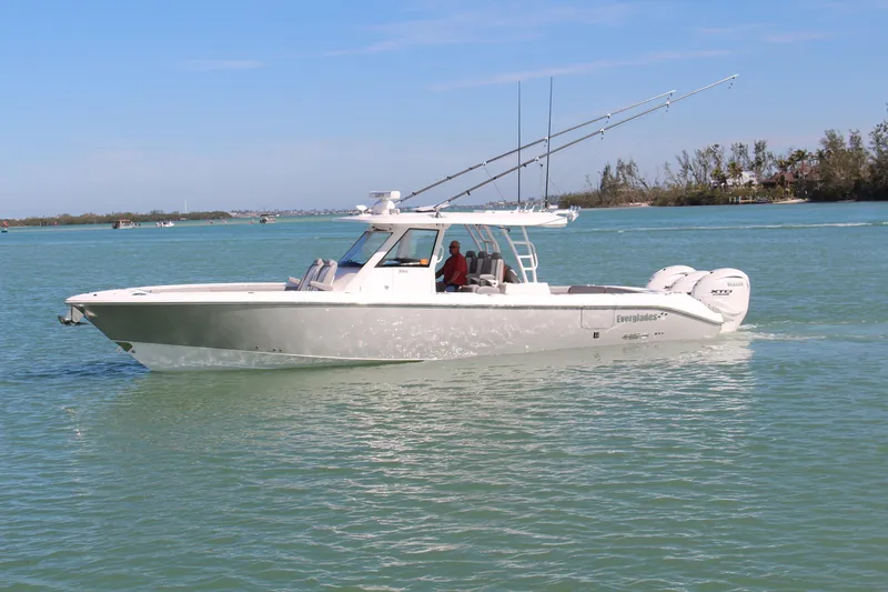  Yacht Photos Pics 2024 Everglades 395 Center Console boat cruising on calm waters.