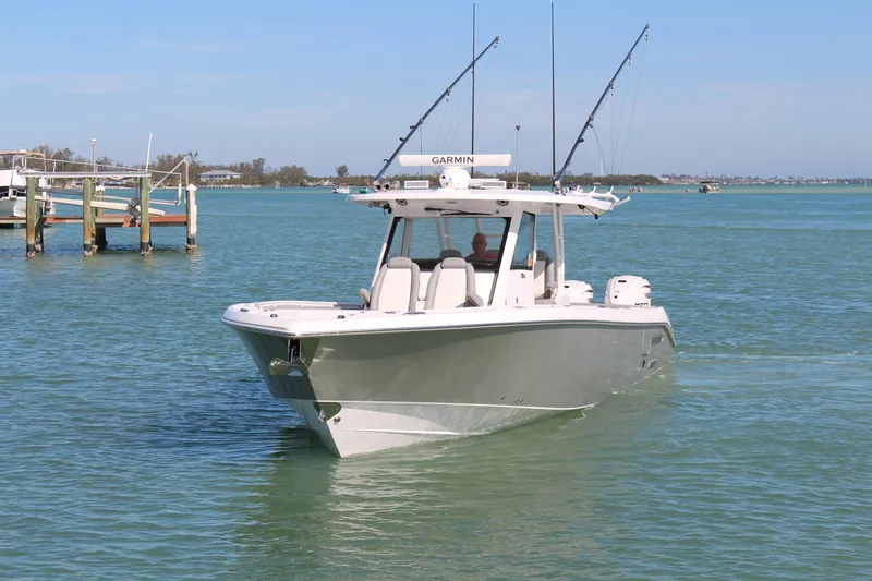  Yacht Photos Pics 2024 Everglades 395 Center Console boat cruising on clear blue water.