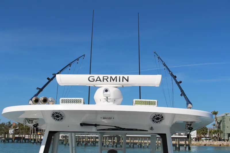  Yacht Photos Pics 2024 Everglades 395 Center Console boat with Garmin equipment, docked under clear blue sky.