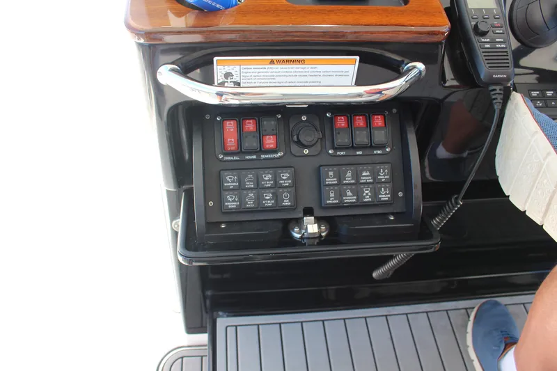  Yacht Photos Pics Control panel of 2024 Everglades 395 Center Console boat with switches and warning label.