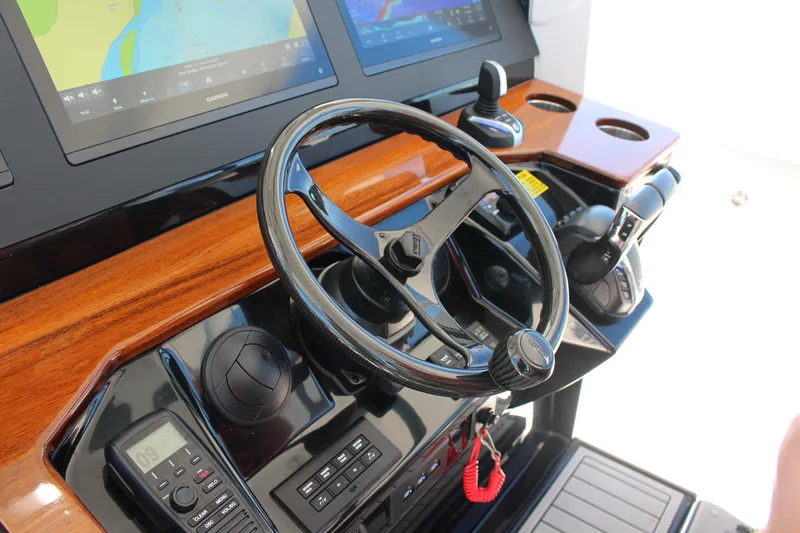 Yacht Photos Pics 2024 Everglades 395 Center Console helm with steering wheel and navigation displays.
