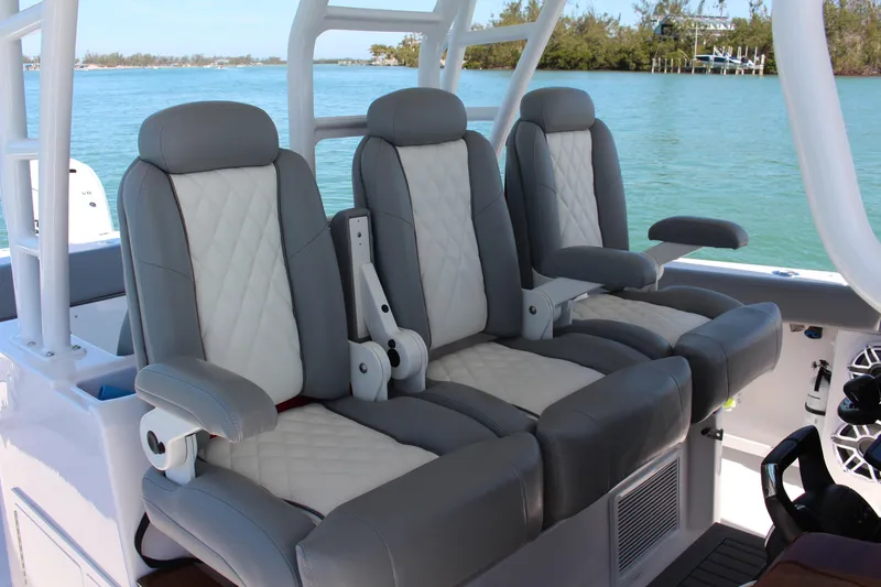  Yacht Photos Pics Luxurious seating on 2024 Everglades 395 Center Console boat, featuring plush gray and white upholstery.
