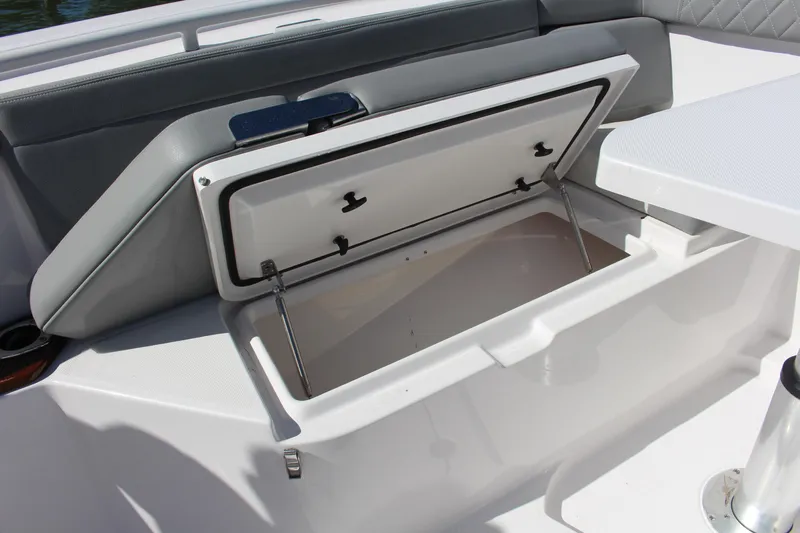  Yacht Photos Pics 2024 Everglades 395 Center Console storage compartment with open lid, showcasing interior space.