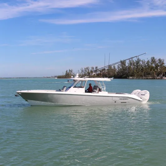  Yacht Photos Pics 2024 Everglades 395 Center Console boat cruising on calm water.