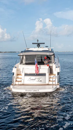  Yacht Photos Pics 2024 Riviera 4600 SY yacht cruising on open water, rear view.