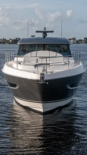  Yacht Photos Pics 2024 Riviera 4600 SY luxury yacht on calm water, front view.