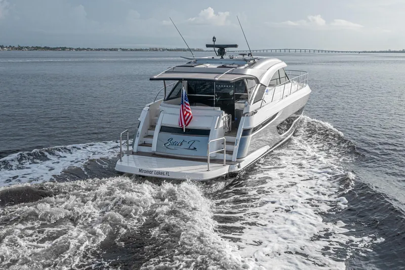  Yacht Photos Pics 2024 Riviera 4600 SY luxury yacht cruising on open water.