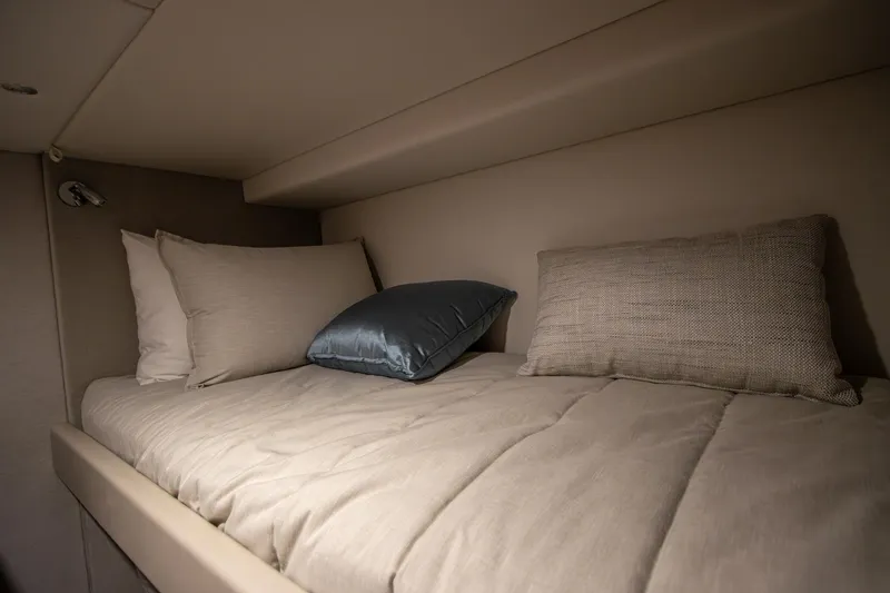  Yacht Photos Pics 2024 Riviera 4600 SY cabin with cozy bedding and pillows.