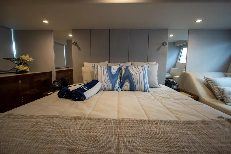  Yacht Photos Pics Luxurious bedroom interior of 2024 Riviera 4600 SY yacht with elegant bedding and decor.
